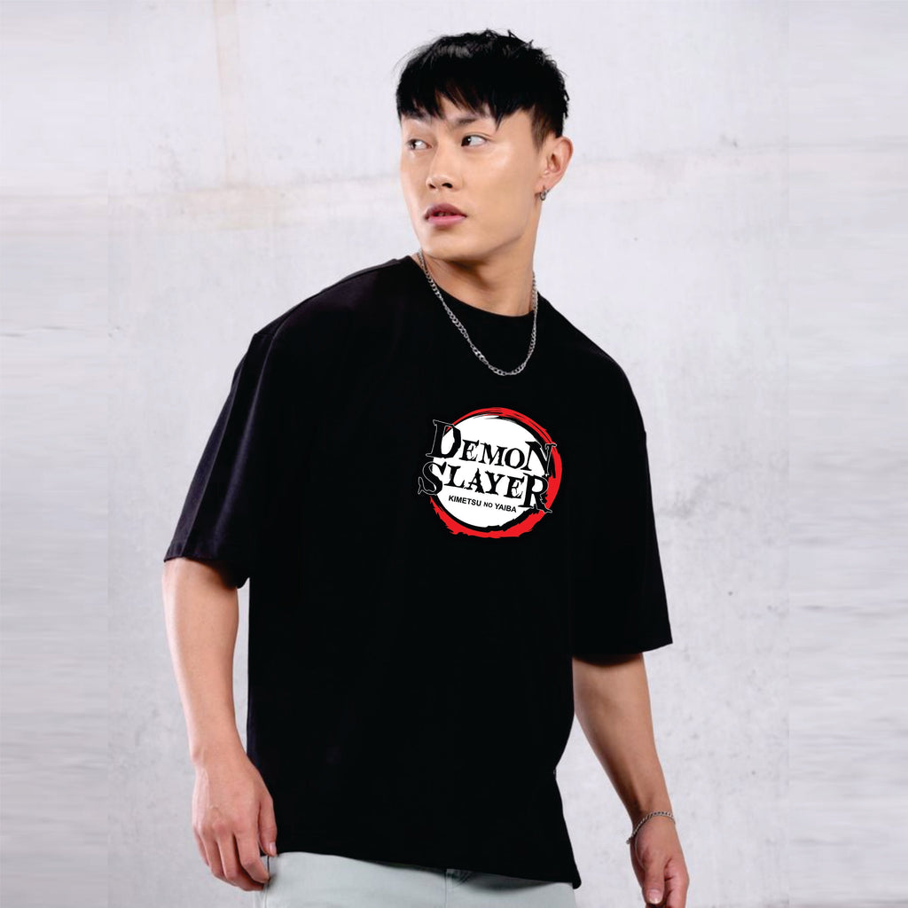 Person wearing a black t-shirt with 'Demon Slayer' logo against a plain background