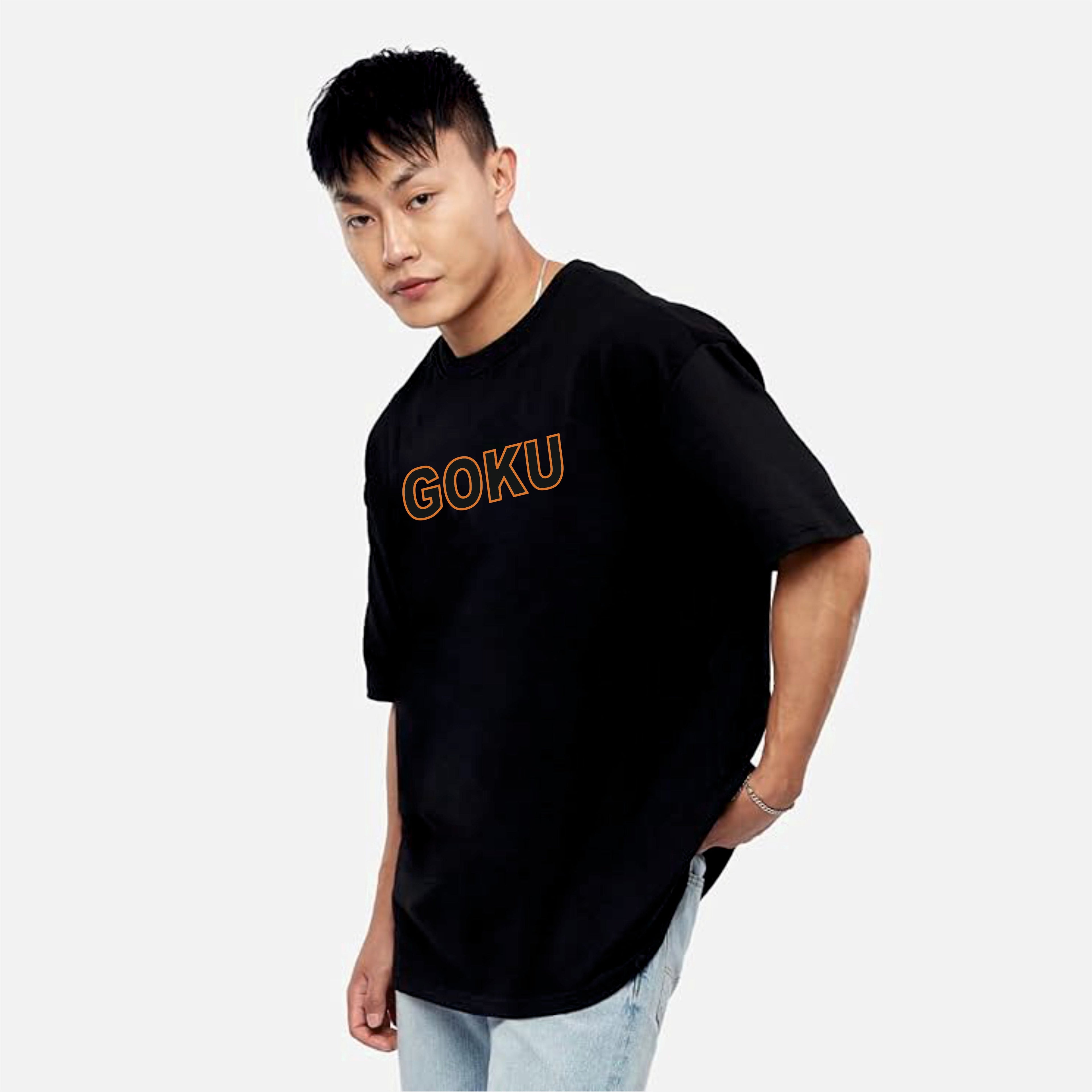 Person wearing a black t-shirt with 'GOKU' printed in orange 