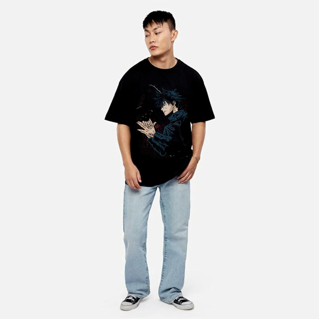Person wearing a black t-shirt with a graphic design and light blue jeans