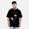 Person wearing a black t-shirt with an anime character design