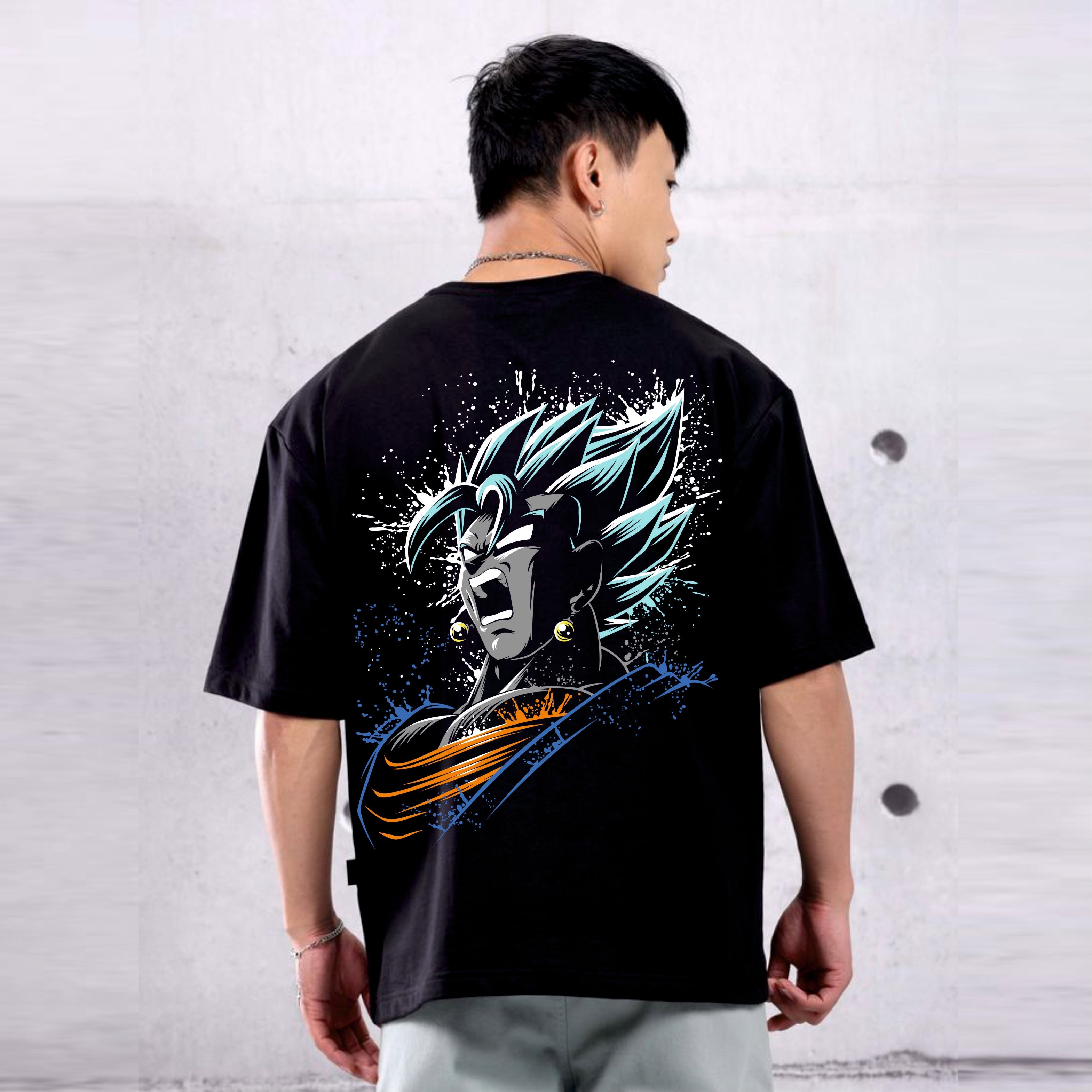 Person wearing a black t-shirt with a colorful graphic Goku design on the back, standing against a light gray wall.