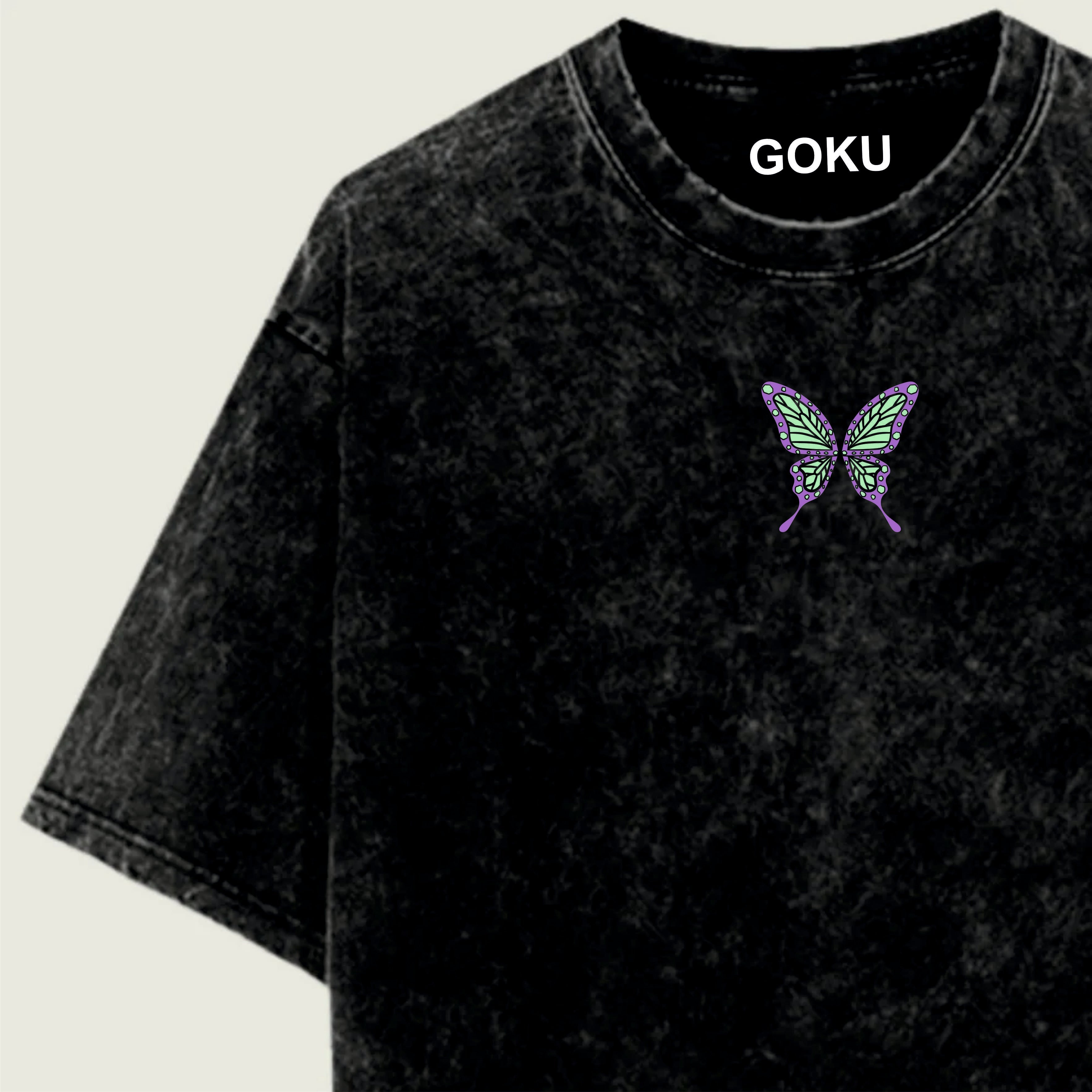 Black t-shirt with a butterfly design and 'GOKU' text on a light green background