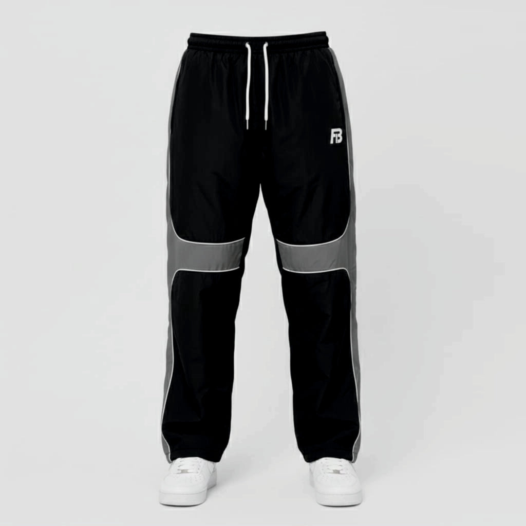 Black and gray track pants with a brand logo on a light gray background