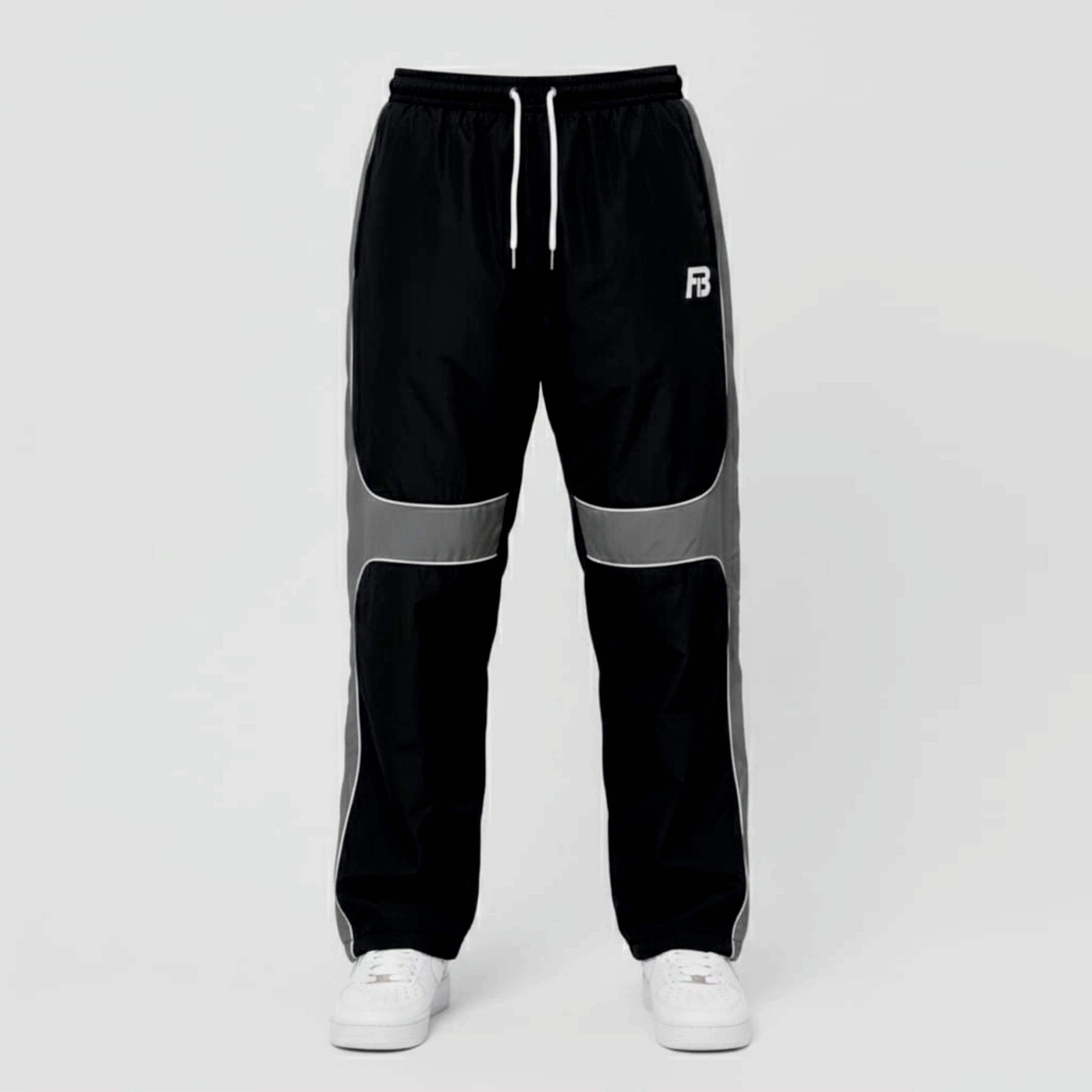 Black and gray track pants with a brand logo on a light gray background