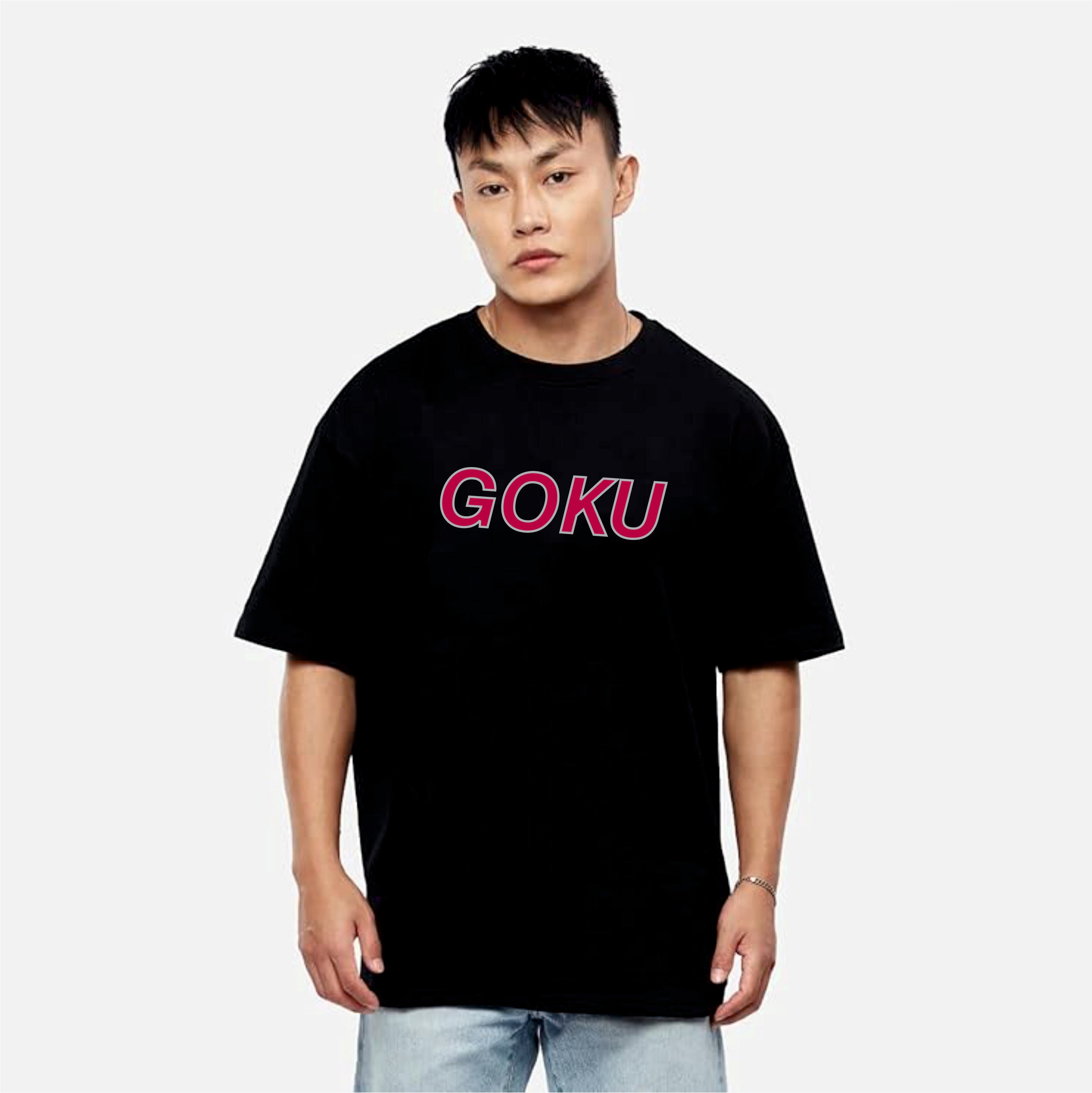Person wearing a black t-shirt with 'GOKU' in pink on a white background