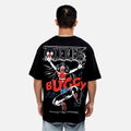 Person wearing a black t-shirt with a colorful design on the back, featuring a character and text.