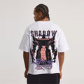 Person wearing a white t-shirt with a graphic design on the back.