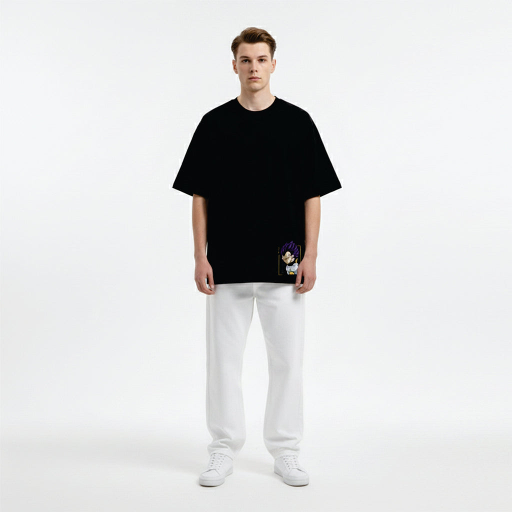 Person wearing a black oversized t-shirt and white pants on a white background