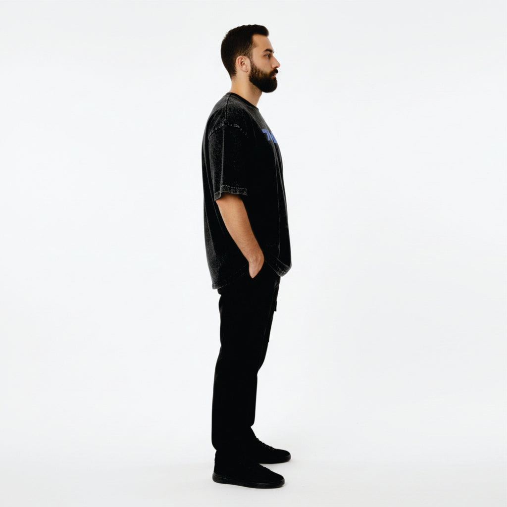 Man wearing a black outfit with a logo on a white background