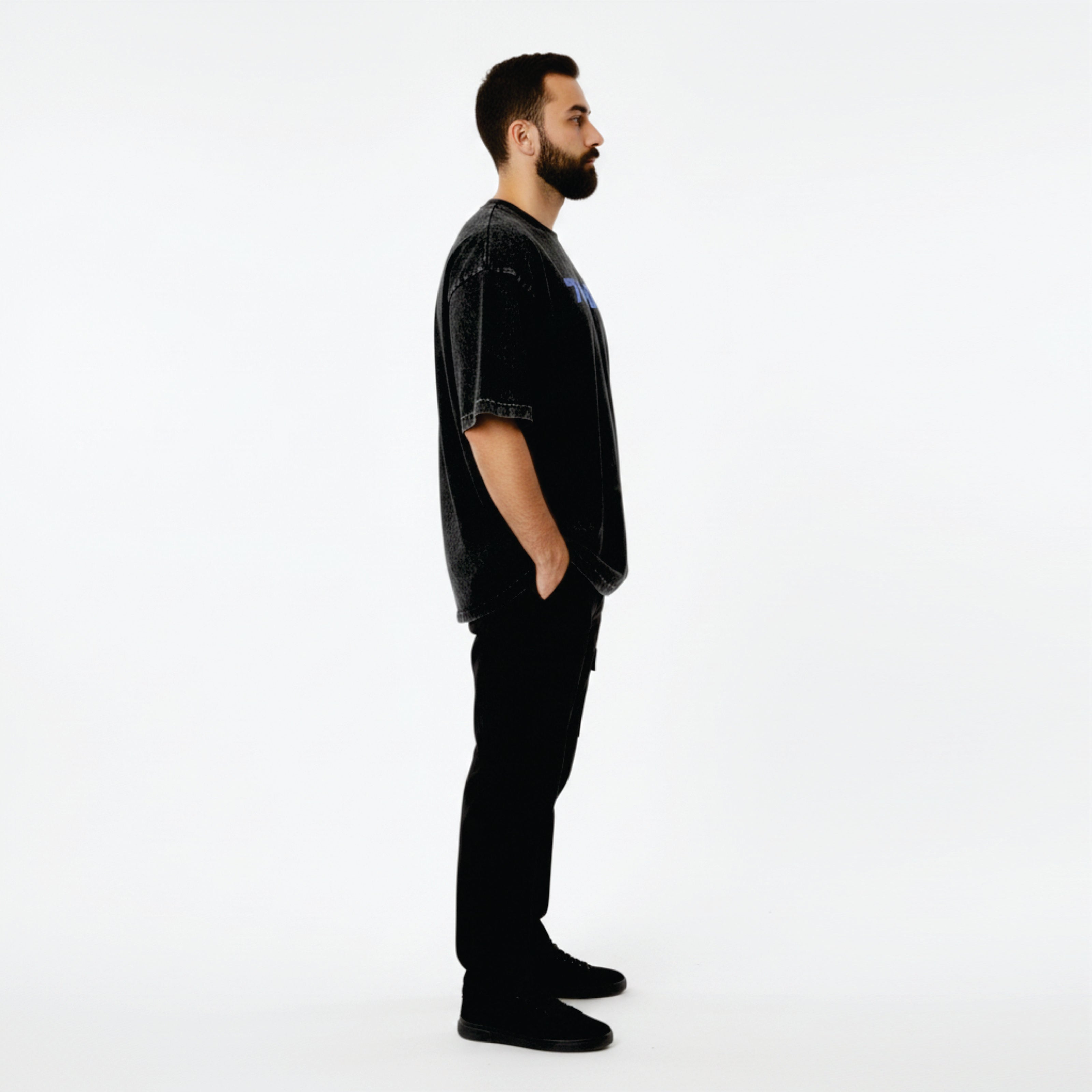 Man wearing a black outfit with a logo on a white background