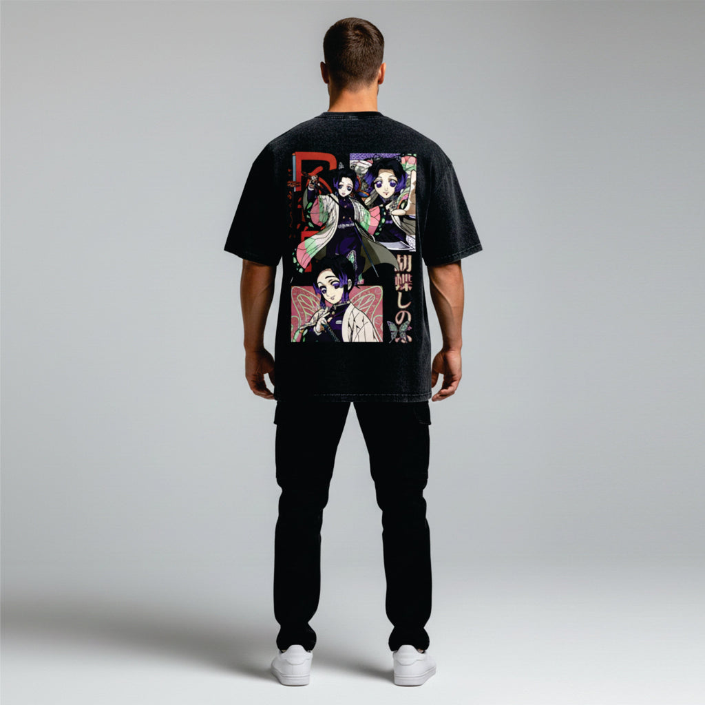 Person wearing a black t-shirt with colorful graphic design on the back against a light gray background