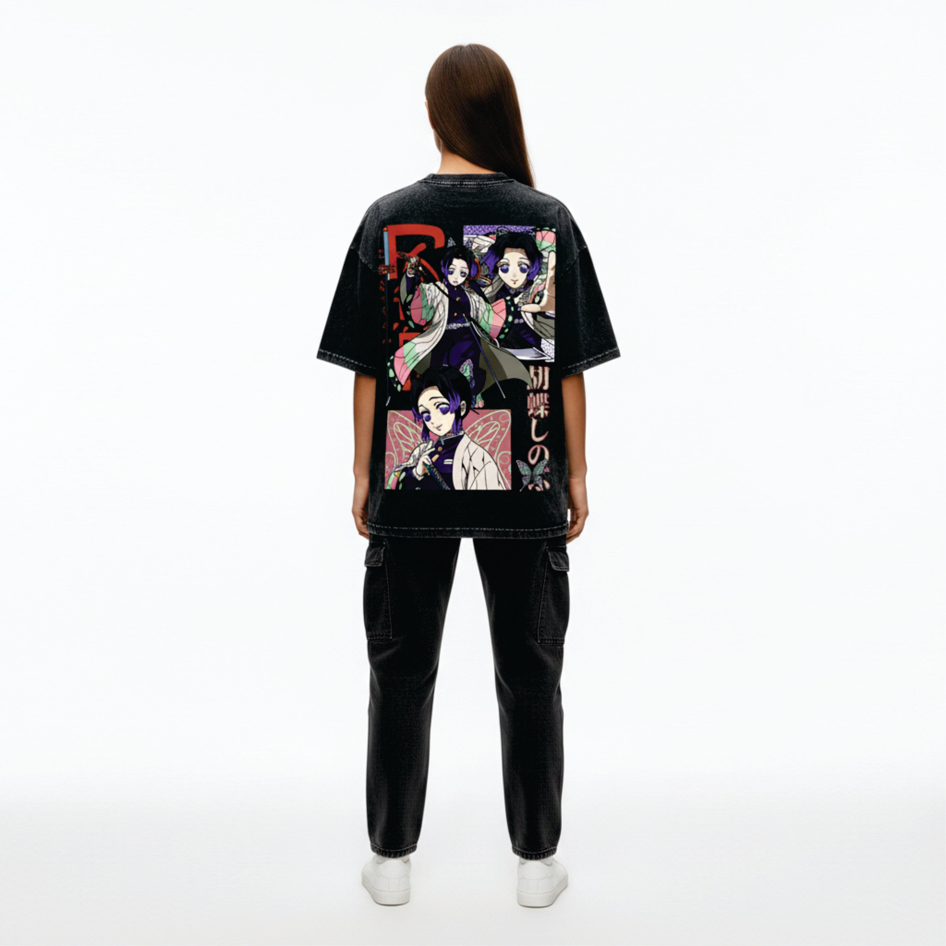 Person wearing a black t-shirt with colorful graphic design on the back, standing against a white background
