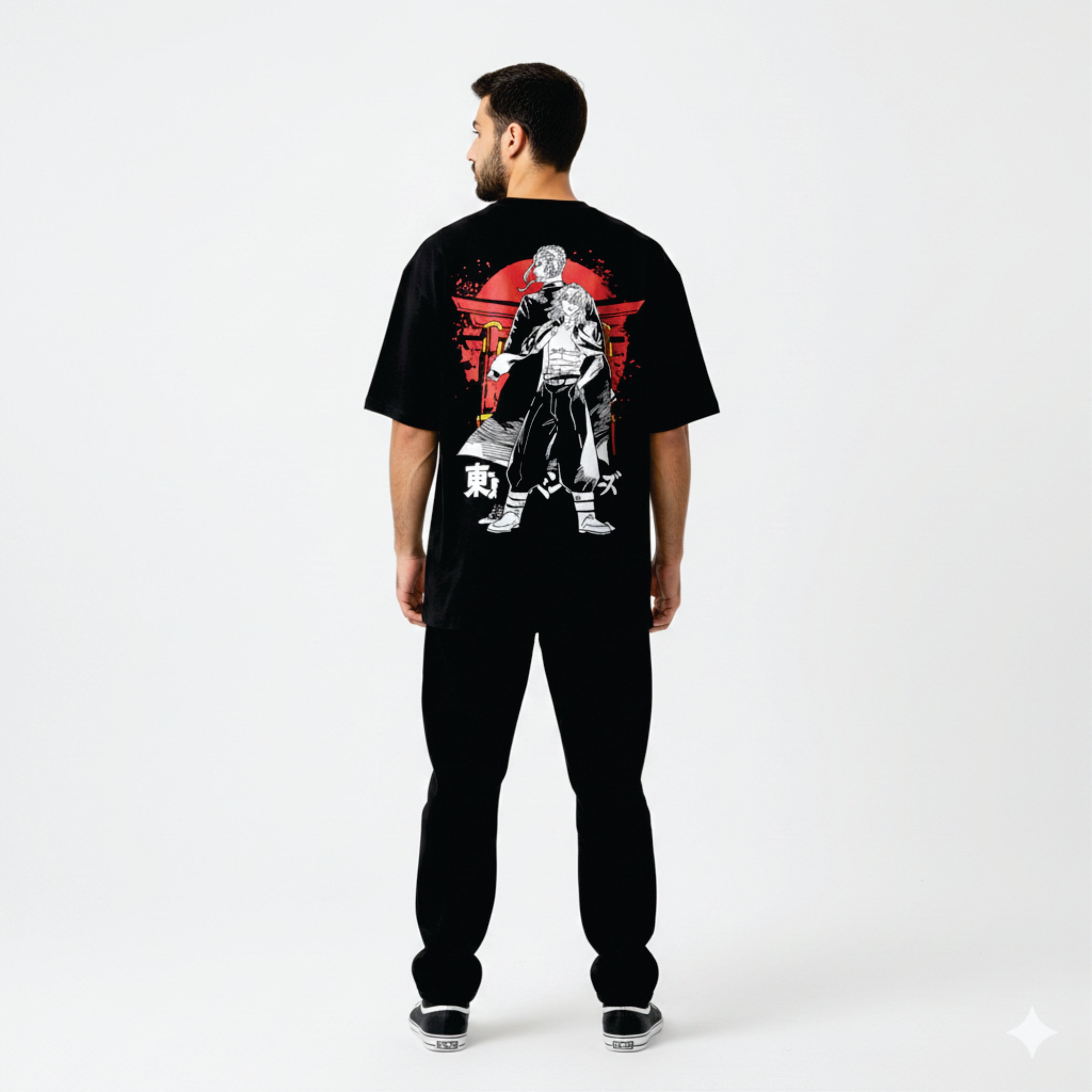 Person wearing a black t-shirt with a graphic design on the back, standing against a white background