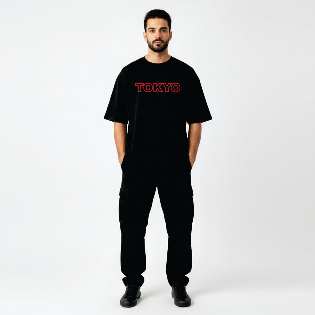 Person wearing a black t-shirt with 'TOKYO' printed in red on a white background
