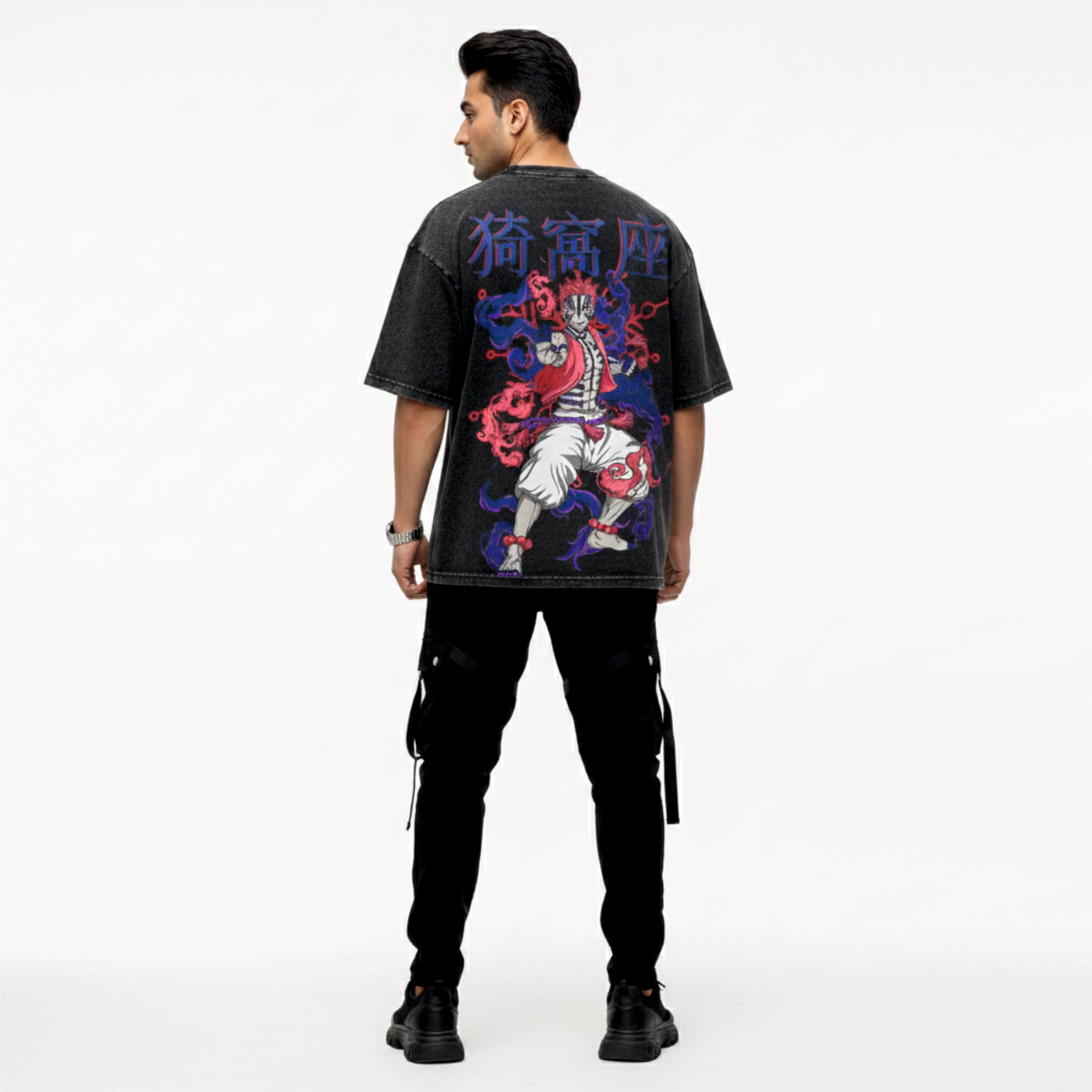 Person wearing a black t-shirt with colorful graphic design on the back, standing against a white background